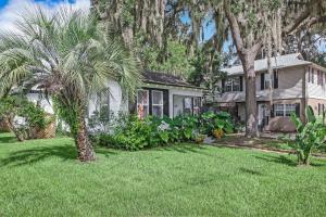 a house with a palm tree in a yard at Charming St Augustine Oasis with Game Room for Family fun in St. Augustine