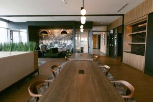 a long wooden table in a room with chairs at Atl oasis in Atlanta +18 photos