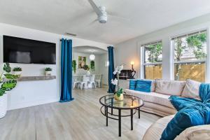 a living room with a couch and a table at Charming St Augustine Oasis with Game Room for Family fun in St. Augustine