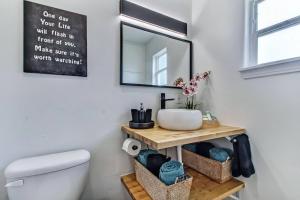 a bathroom with a sink and a mirror at Charming St Augustine Oasis with Game Room for Family fun in St. Augustine +44 photos