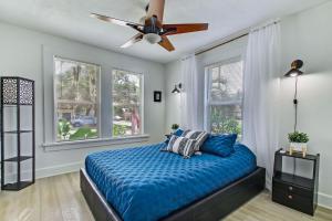 a bedroom with a bed and a ceiling fan at Charming St Augustine Oasis with Game Room for Family fun in St. Augustine