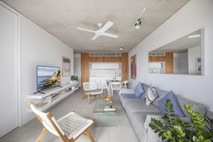 a living room with a couch and a table at Modern Beach Ocean View 1 BDR Parking Balcony AC in Sydney