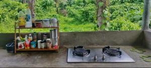 a stove top with pots and pans on a patio at SUMMER HOUSE B Starlink in General Luna