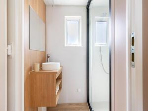 a bathroom with a sink and a shower at New Vennepark caravan 463 6p in De Haan +32 photos