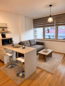 a living room with a couch and a table at FONTANA DELUXE Apartment in Budva