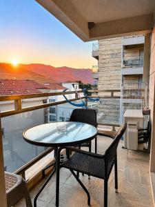 a table and chairs on a balcony with a view at FONTANA DELUXE Apartment in Budva