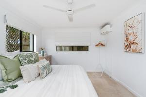 a white room with a bed and a window at Absolute Beachfront Retreat - Private Beach TOOGOOM in Fraser Island