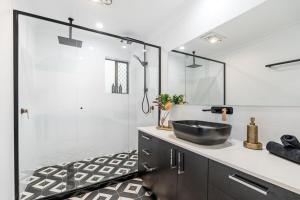 a bathroom with a sink and a shower at Absolute Beachfront Retreat - Private Beach TOOGOOM in Fraser Island +34 photos