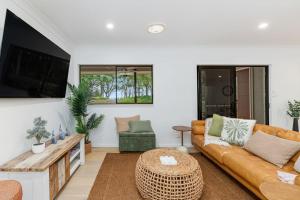 a living room with a couch and a table at Absolute Beachfront Retreat - Private Beach TOOGOOM in Fraser Island