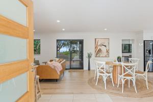 a living room with a table and chairs at Absolute Beachfront Retreat - Private Beach TOOGOOM in Fraser Island
