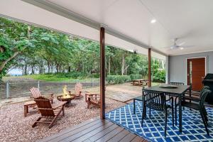 a screened in porch with a table and chairs at Absolute Beachfront Retreat - Private Beach TOOGOOM in Fraser Island