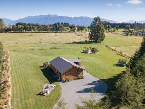 an aerial view of a small house in a field at Whakatā in Te Anau