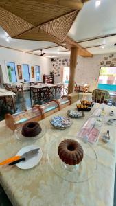 a table with some donuts on top of it at Pousada Tribo Ubatuba in Ubatuba