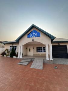 a house with a blue window on the front of it at Mavis Lodge in Janman