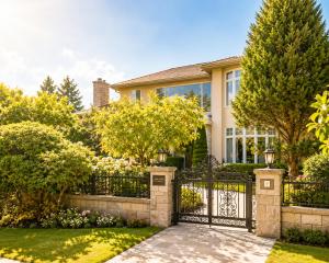 a house with a gate and a garden at Van Nest near YVR UBC Downtown Free Parking in Vancouver