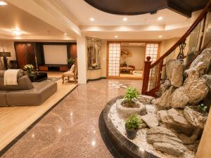 a living room with a large rock wall at Van Nest near YVR UBC Downtown Free Parking in Vancouver