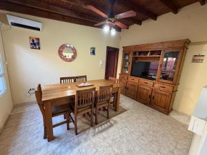 a dining room with a wooden table and chairs at Refugio serrano in Tandil