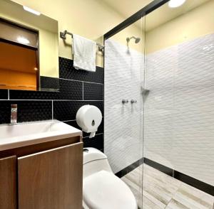 a bathroom with a toilet and a sink and a shower at Hotel Plaza Garibaldi in Caldas +134 photos