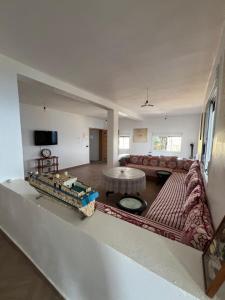a living room with a couch and a table at La Vista Azul in Belyounech 
