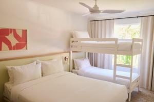 a bedroom with two bunk beds and a window at The Roy in Rainbow Beach