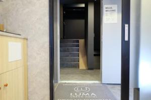 a hallway with a stairway leading to a building at Luma Urban Hotel 高田馬場 in Tokyo