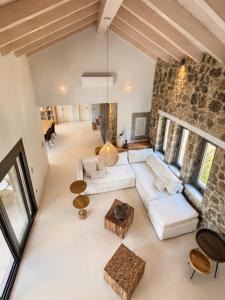 an open living room with a white couch and tables at Villa Tartaya Boutique Villa with Private Pool in Corfu in Dassia +51 photos