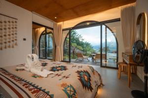 a bedroom with a bed with an animal on it at Stone Ridge Kintamani in Kintamani