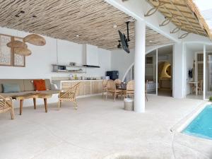 a kitchen and living room with a swimming pool at Villa Sei Uluwatu by LODGELINK BALI in Uluwatu