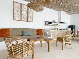 a living room with a couch and a table and chairs at Villa Sei Uluwatu by LODGELINK BALI in Uluwatu