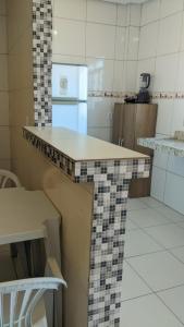 a kitchen with a counter top in a room at Apartamento aconchegante in Marabá +25 photos
