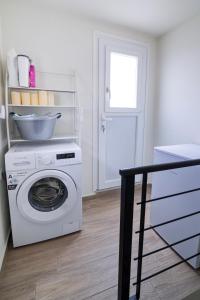 a washing machine with a bowl on top of it at Villa St George in Kalymnos
