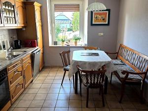 a kitchen with a table and chairs and a window at Holiday Home in Badem in Badem