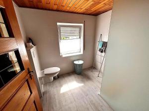 a small bathroom with a toilet and a window at Holiday Home in Badem in Badem +17 photos