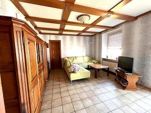 a living room with a couch and a tv at Holiday Home in Badem in Badem