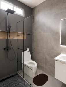 a bathroom with a shower with a toilet and a sink at Villa renacer 1 in Baní +19 photos
