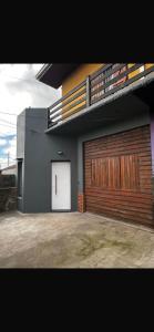 a building with a garage with a white door at Costa Edison in Mar del Plata