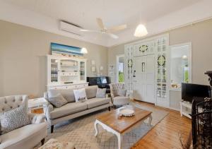 a living room with a couch and a table at Cork Hill Retreat in Cape Bridgewater