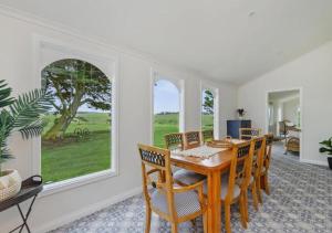 a dining room with a table and chairs and a window at Cork Hill Retreat in Cape Bridgewater