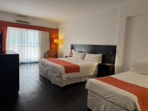 a hotel room with two beds and a window at Duomi Hotel Buenos Aires in Buenos Aires +68 photos