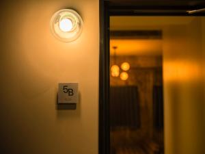 a lightswitch on a wall next to a mirror at SHIFT HOTEL Shibuya Jinnan in Tokyo