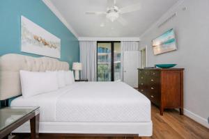 a bedroom with a white bed and a window at Phoenix on the Bay 1320 in Orange Beach +36 photos