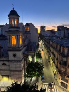 a building with orange lights on a city street at Duomi Hotel Buenos Aires in Buenos Aires