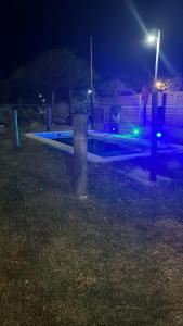 a park bench at night with blue lights at El triángulo finca familiar in Maco +7 photos
