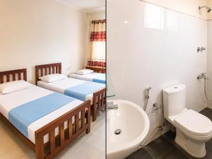 two beds in a room with a toilet and a sink at The Green View Guest House Haputale in Haputale +41 photos