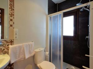 a bathroom with a toilet and a sink and a shower at Beautiful villa with jacuzzi in Canillas de Albaida +22 photos