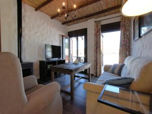 a living room with a couch and a table at Beautiful villa with jacuzzi in Canillas de Albaida