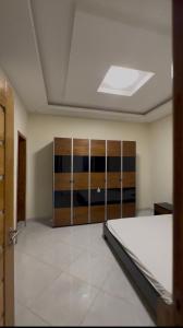 an empty room with a bed and a closet at La résidence des lions in Thiès