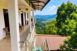 a balcony with a view of the mountains at The Green View Guest House Haputale in Haputale