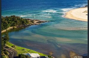 an aerial view of a beach and the ocean at Coasters 27 in Sawtell