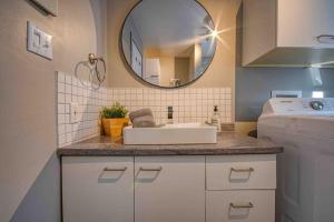 a bathroom with a sink and a mirror at Chalet familial, idéalement situé, billard-table-babyfoot-arcade in Saint-Faustin +39 photos